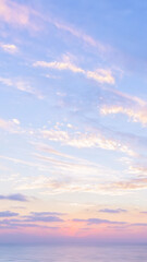 Obraz premium Vertical minimalist pastel sunset sky background with soft focus blur sea. Mobile phone nature wallpaper, banner, abstract design element. Copy space.