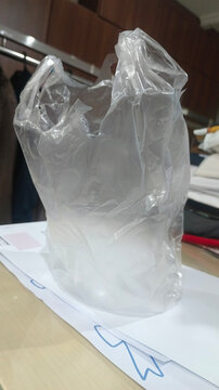 Clear plastic bag rests on a white surface