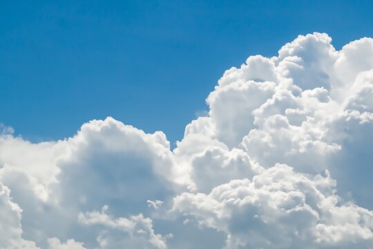 Bright Blue Sky with Fluffy White Clouds Overhead.