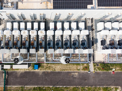 Aerial view of Vantage Data Centre - MXP1 featuring rows of industrial cooling units, technical infrastructure, and rooftop solar panels in Melegnano, Lombardia, Italy.