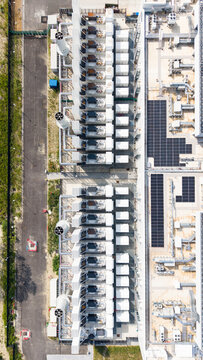 Aerial view of Vantage Data Centre - MXP1 featuring rows of cooling units, industrial infrastructure, and solar panels on the rooftop, Melegnano, Lombardia, Italy.