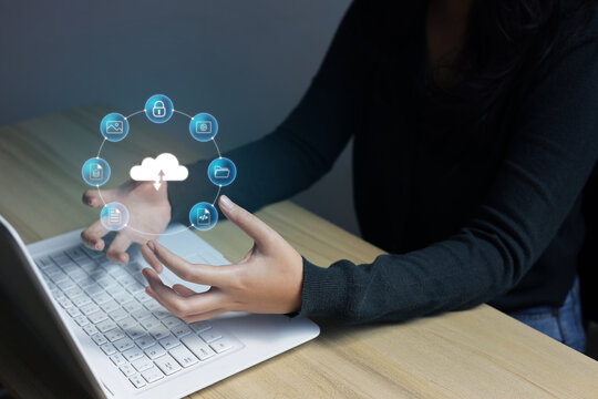High angle of female hands framing with clouds storage above the laptop