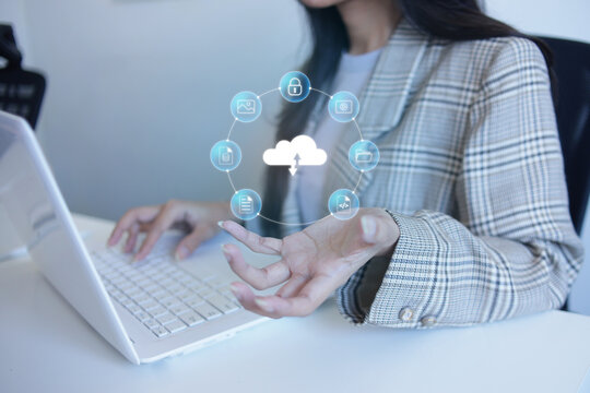 Professional Female Typing On Laptop While Presenting Cloud Graphics Data Management