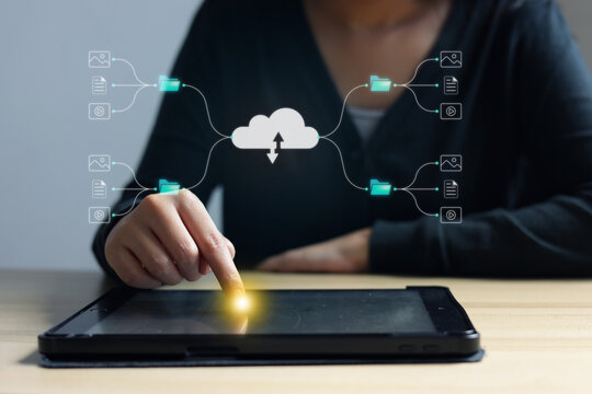 Close Up Of Hand Touching Digital Tablet For Data Management On Office Desk