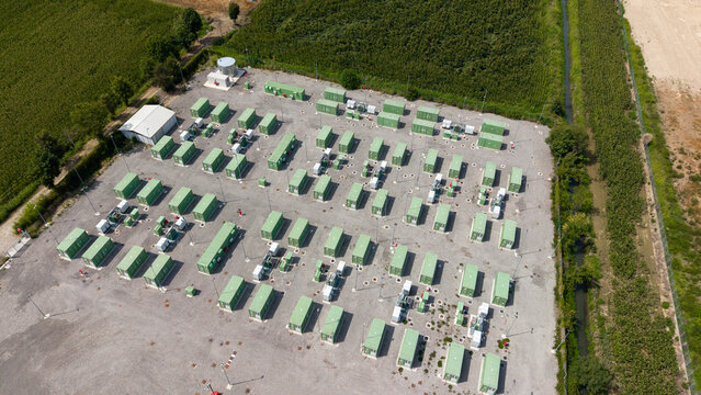Aerial view of the BESS Serre Tavazzano battery energy storage system, featuring rows of green storage containers on a gravel site in Tavazzano con Villavesco, Lombardy, Italy.