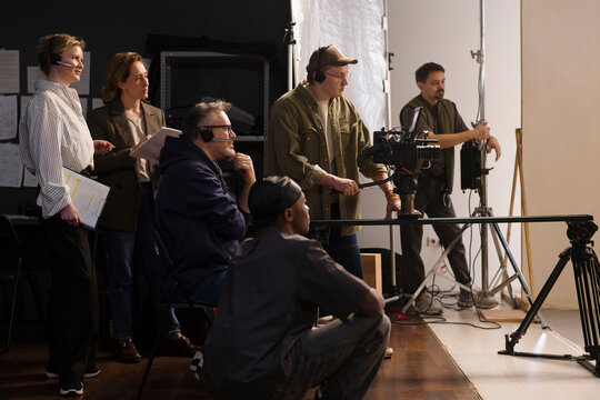 Film crew working together on a production set in a studio