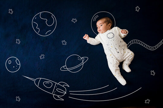 Astronaut baby boy in outer space