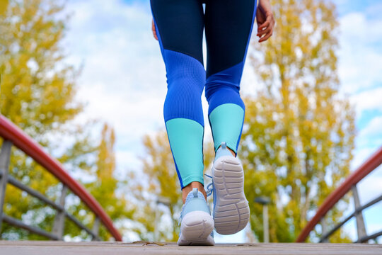 Sportswoman walking on footbridge