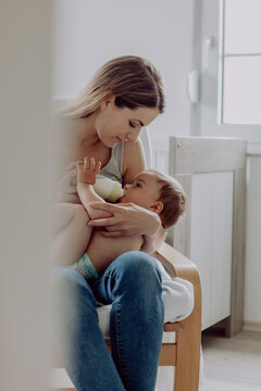 Mother feeding her baby son