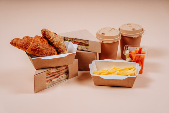 Fast foods with coffee cups against beige background
