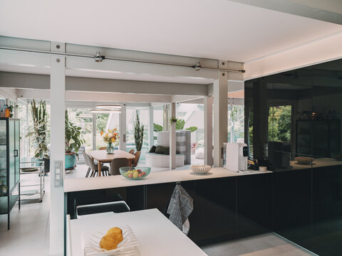 Modern black kitchen and dining area in luxury timber frame house