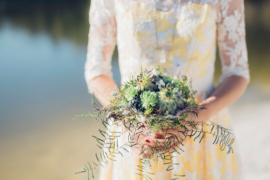 Woman holding bridal bouquet, close-up