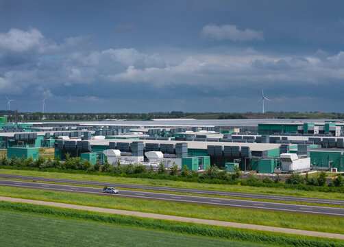 A large data center operates under dark rainclouds in Middenmeer