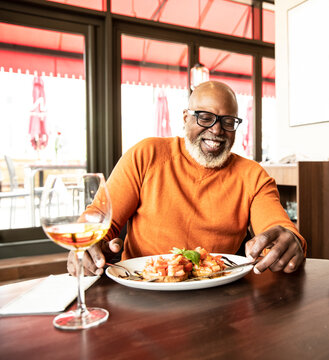 Happy man enjoying food at restaurant