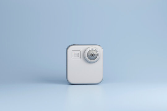 Compact white action camera on minimal blue background