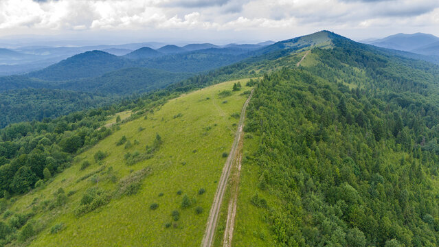 Drone view of the Carpathian mountain range with traces of soil erosion from the passage of cars and transport. Problems of jeeping in the Carpathians and mountains.