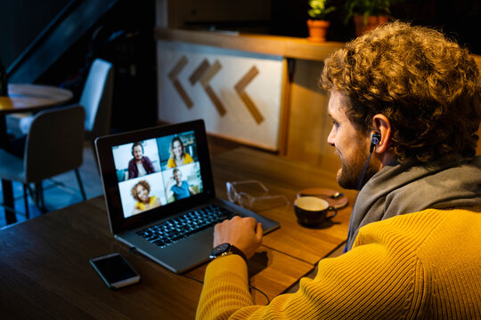 Businessman doing video call on laptop while sitting at cafe