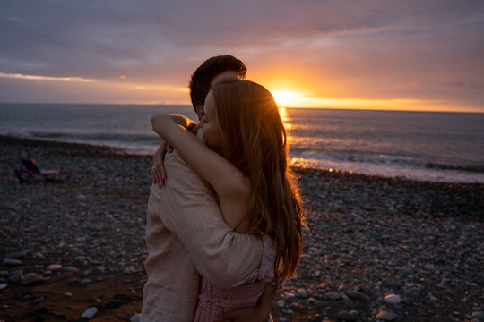 Young romantic couple embracing each other at beach