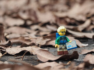 Fototapeta premium Indonesia - November 27, 2019 : Mini toy of action figure at grassland with blurred background. Toy photography concept. Adventure man at grass land conceptual design.