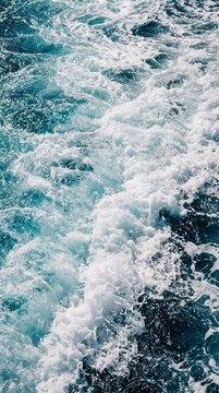 High Angle Perspective of Powerful Ship Wake in the Ocean with Splashing Turquoise Water Waves and Thick Layers of White Sea Foam Texture Background