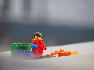 Fototapeta premium Indonesia - April 5, 2024 : Mini toy of action figure at table with blurred background. Toy photography concept. Construction conceptual design.