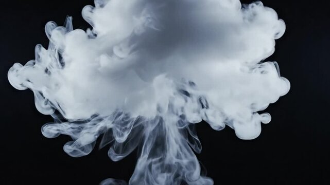 Abstract cloud of white smoke expanding against a dark black background, slow motion simulation