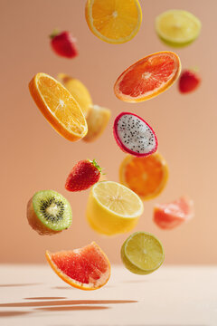 Assorted fresh fruit slices floating mid-air in a dynamic, minimalist composition