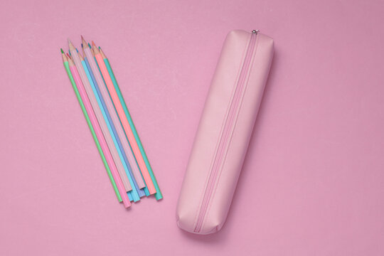 School pencil case with colored pencils on a pink background. Back to school concept