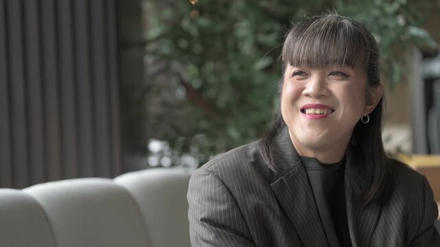 Horizontal Portrait of Asian Person Looking Through Window Smiling Happily
