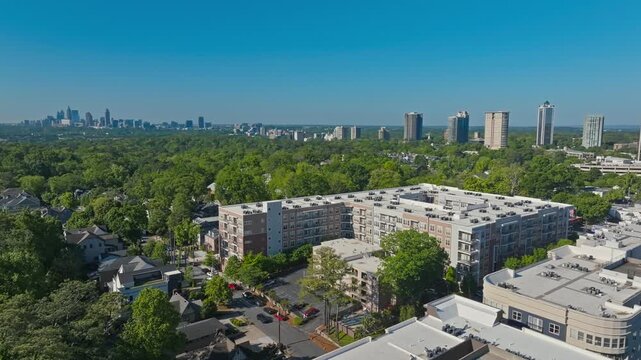 Aerial view of Buckhead residential neighbourhood surrounding dense green space with Downtown Atlanta skyscrapers at far, Atlanta, Georgia