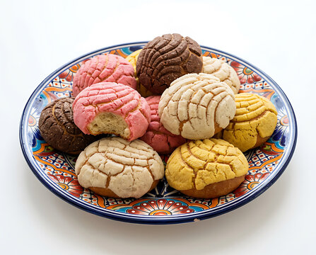 Celebrating Day of the Dead with sweet pan de muerto bread on a colorful plate