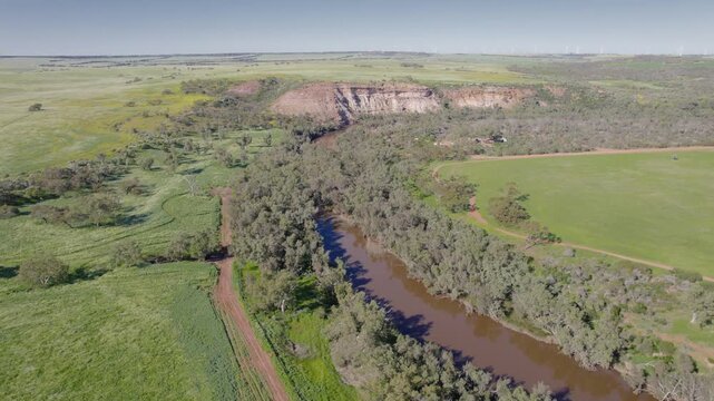 Ellendale Pool Waterhole surrounded by Green Floodplain and Sandstone Cliffs near Geraldton Western Australia, Aerial Drone Shot