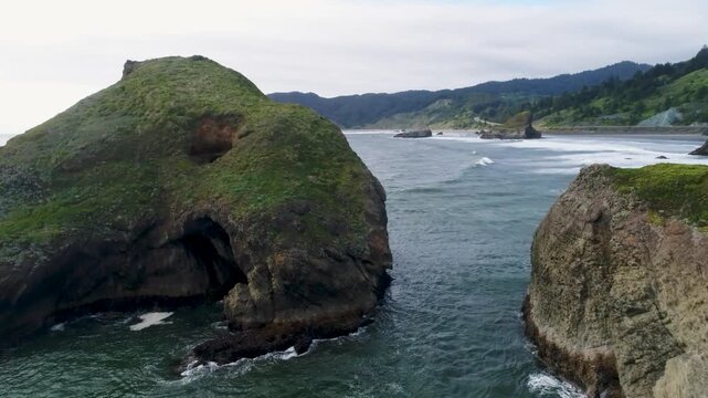 A cinematic drone footage glides forward and low over sea-stacks, and out into the Pacific Ocean horizon, along Ariya&rsquo;s Beach, near Branson Carlton&rsquo;s View on Oregon&rsquo;s southern coast.