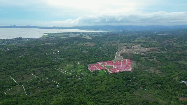 Casa lazarte. Cinematic aerial footage of Rizal Wind Farm in Pililla, Philippines showing renewable energy turbines surrounded by tropical hills and scenic landscapes.