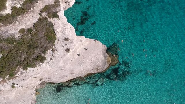 Overhead Aerial View of Limestone Rocks and Crystal Clear Turquoise Sea at Cala Mitjana in Menorca Spain