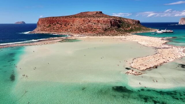 High angle drone photo of Balos beach lagoon with turquoise shallow water, white sand and peninsula in Crete, Greece on a bright sunny summer day.
