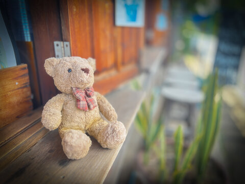 lonely teddy bear sleep on cement floor for created postcard of international missing children, broken heart, lonely, sad, alone unwanted cute doll lost.