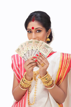 Portrait of Bengali woman holding currency notes 