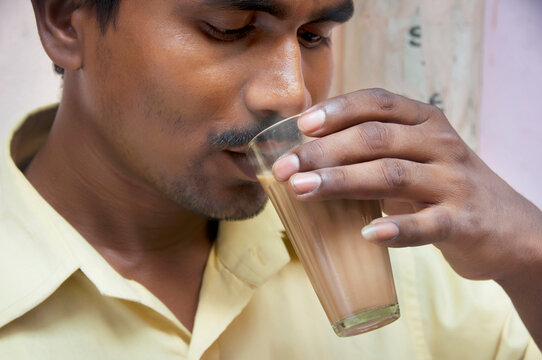 Indian mid adult man drinking morning chai 