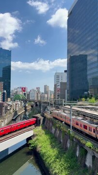 Famous subway and railroad intersection near Ochanomizu Station and Akihabara showing multiple trains passing simultaneously in central Tokyo, Japan.