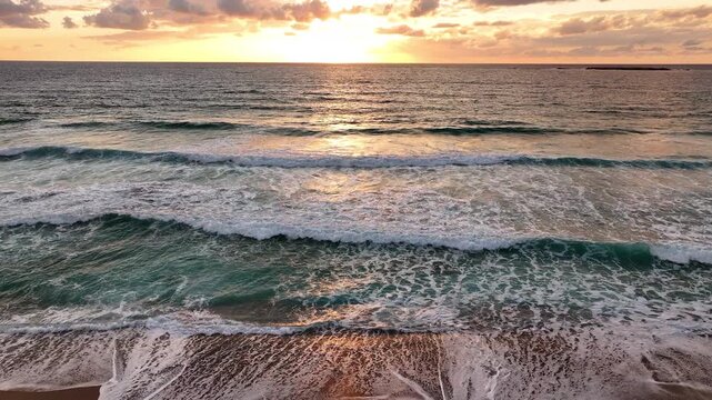 Aerial view of a sandy beach in Greece at sunset