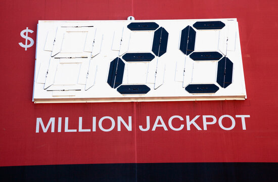A large red display with digital readout of a winning jackpot of $25 million US Dollar.