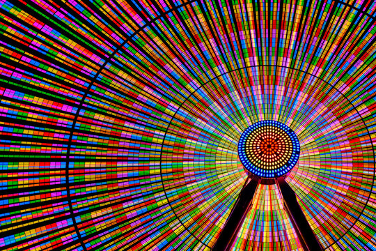 Colourful illuminated ferris wheel at night.