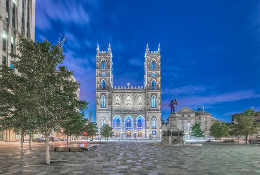 The Notre Dame Basilica, Basilique Notre-Dame de Montreal, a historic 17th century gothic revival church at dusk.