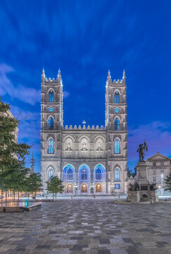 The Notre Dame Basilica, Basilique Notre-Dame de Montreal, a historic 17th century gothic revival church at dusk or dawn.