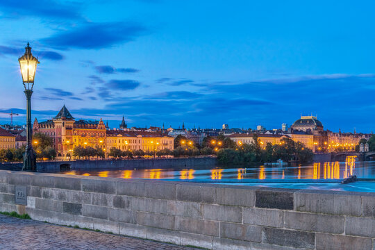 The Charles Bridge at Dawn, and a view of the old town buildings lit up.