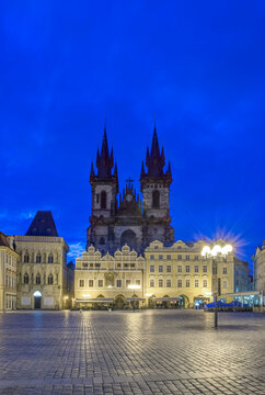 Prague city Old Town Square at night, the Gothic Church of Our Lady before T&yacute;n, silhouette of the twin towers, and outdoor restaurants.
