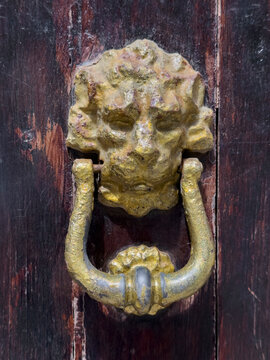 Weathered Door Knocker, the relief of a lion head in Chianalea