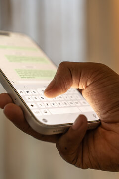 Man hands chatting and typing on smartphone macro closeup.