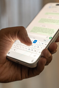 Man hands chatting and typing on smartphone macro closeup.